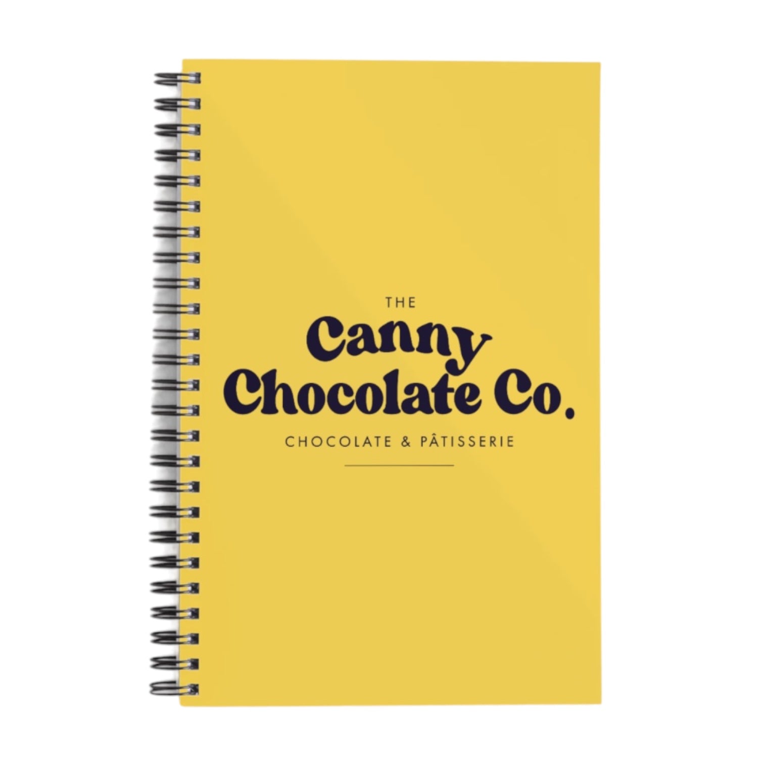 A yellow notepad with the text 'The Canny Chocolate Co chocolate & patisserie' printed on the cover.